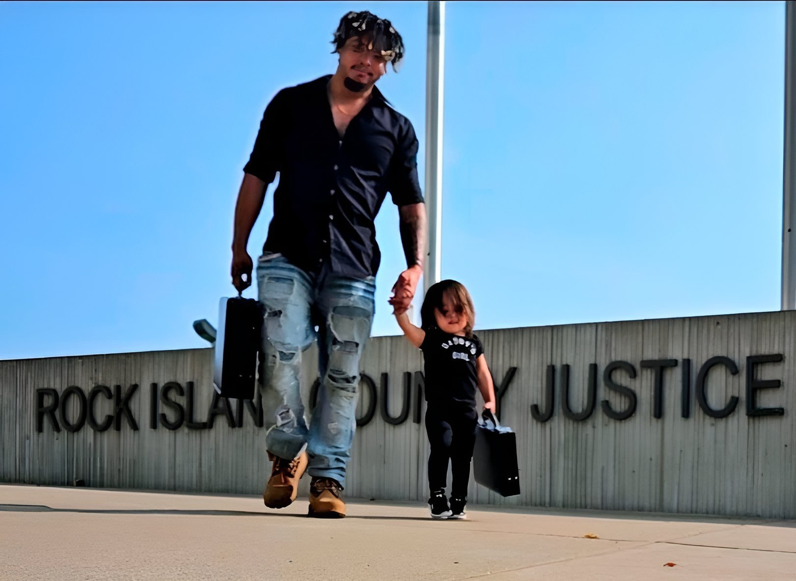 Yoshi walking hand in hand with his daughter
